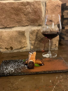 Glass of wine with a desert tray.